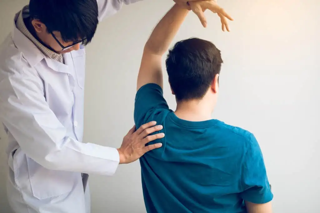 Chiropractor Stretching A Young Man Arm In Medical 2022 12 16 03 39 29 Utc 1024x683