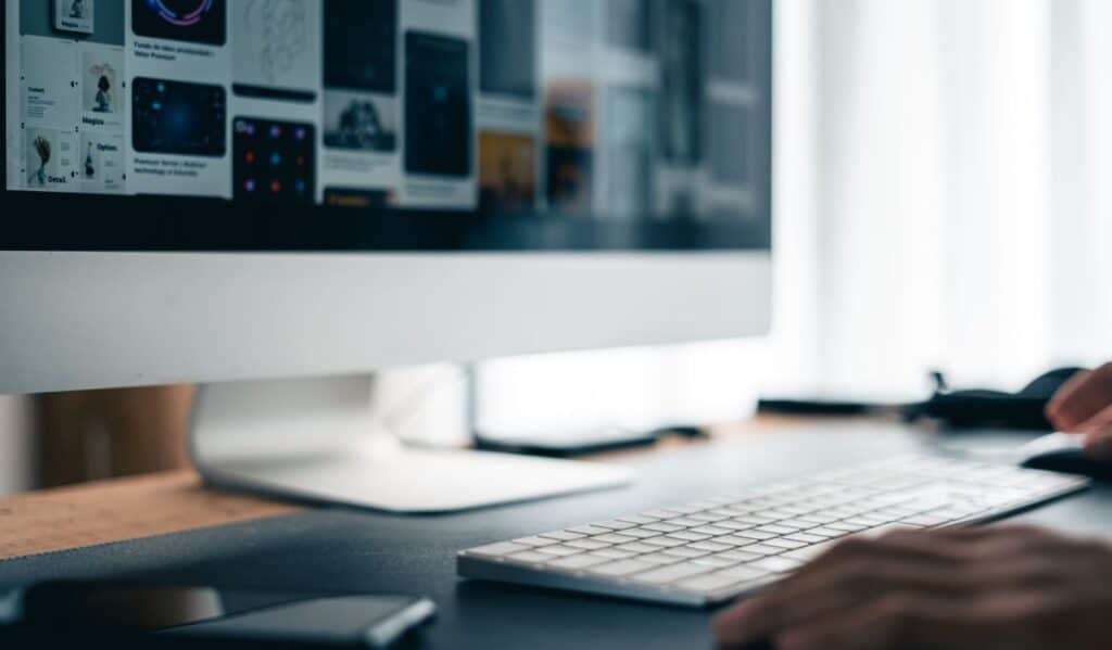 man working on computer desk at home office 